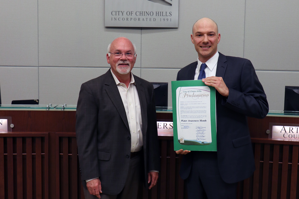 Photo of Water Efficiency Coordinator accepting proclamation naming Water Awareness Month